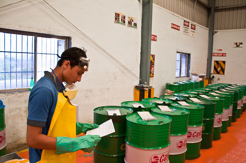 Worker in a warehouse with drums