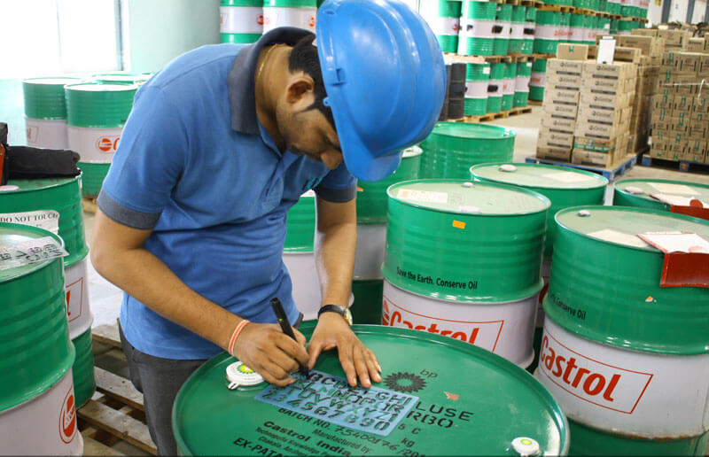 Worker using a stencil in a warehouse