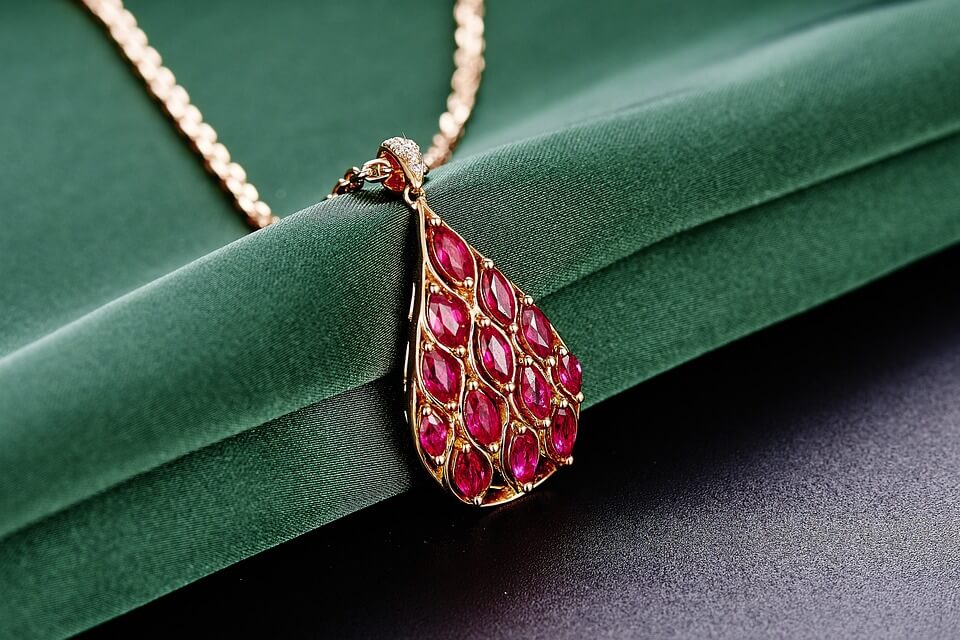 Ruby pendant on green velvet paper