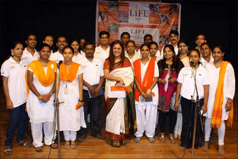 Group photograph of executives on a stage for a corporate event