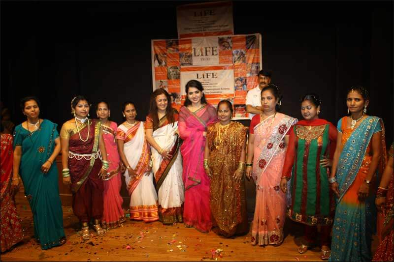 Dr. Indu Shahani with group of women at corporate event