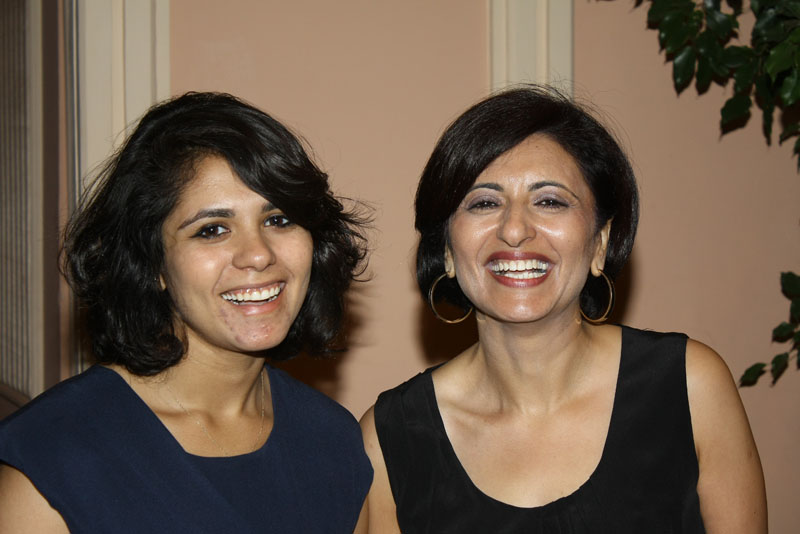 Two women smiling at an event