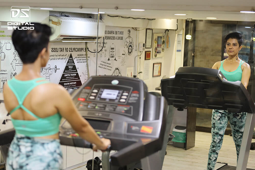 Young fitness model on doing cardio on treadmill