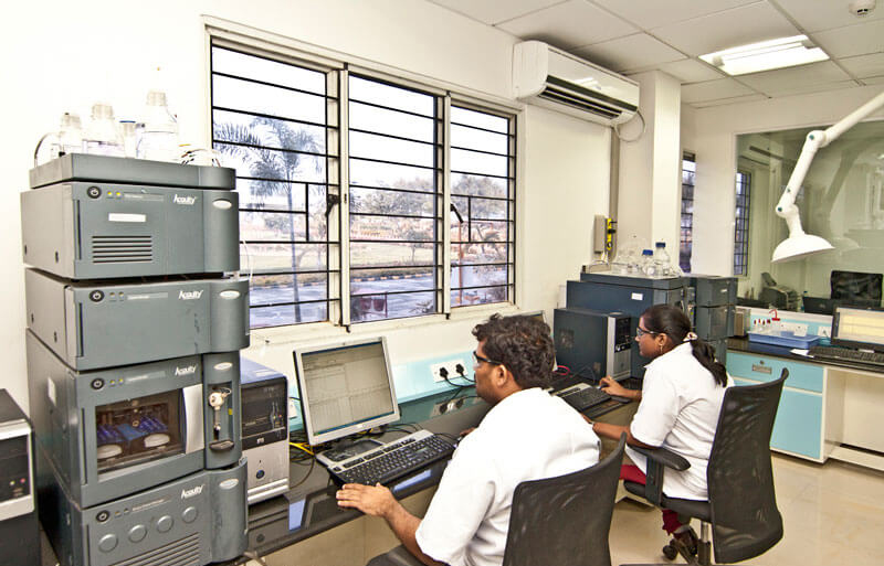 two lab technicians working inside a pharma plant in hyderabad
