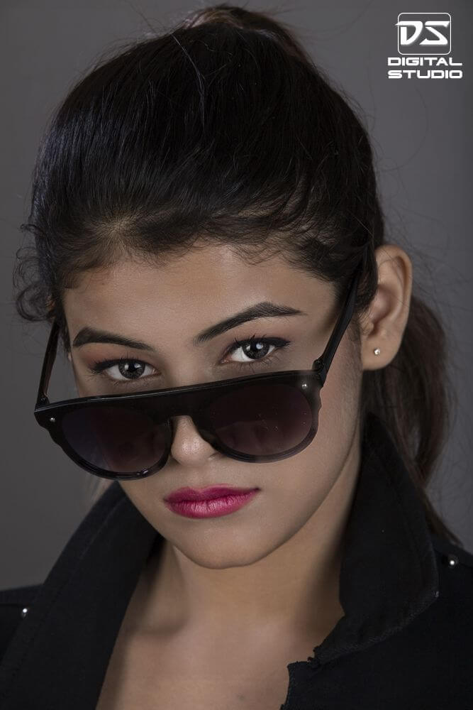 Female model wearing black sunglasses
