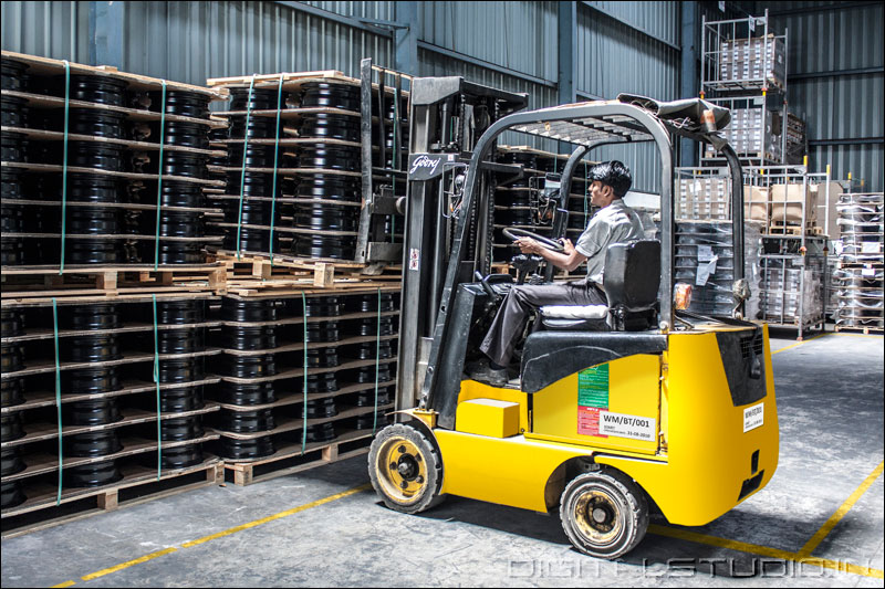 photograph of a worker with forklift in a  warehouse