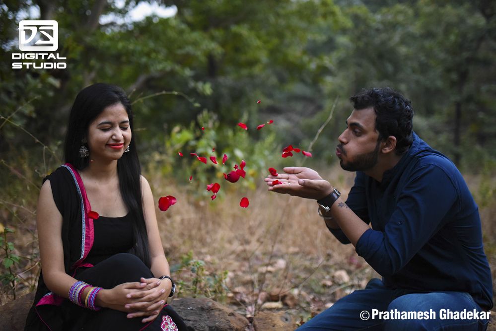 Boy blowing rose petals to the girl - pre Wedding shots