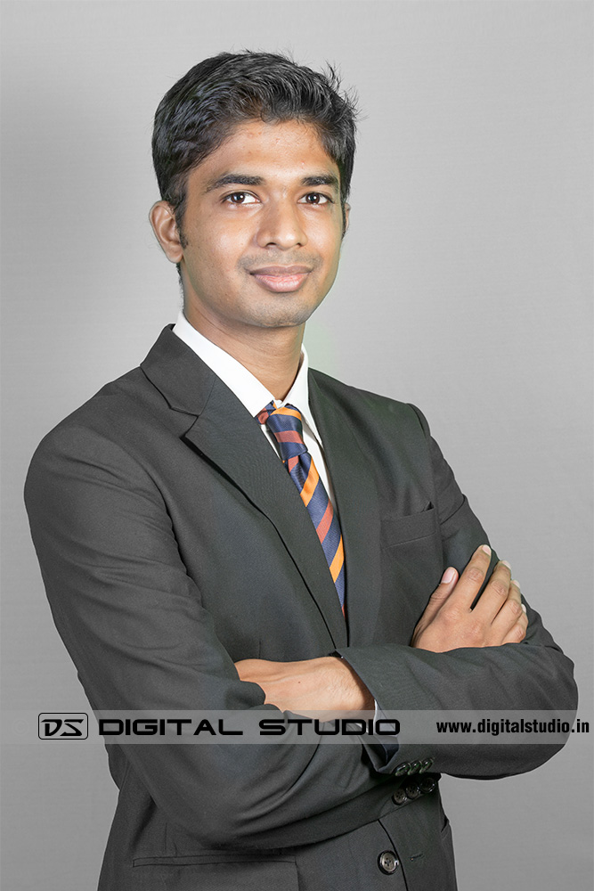 Business suit wearing male executive on grey backdrop