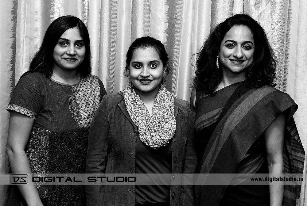 Three lady executives posing for photograph