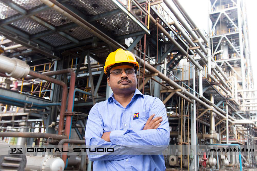 Technician posing in front of factory