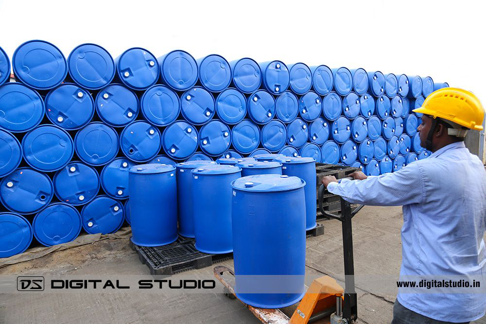 Worker loading the chemical drums