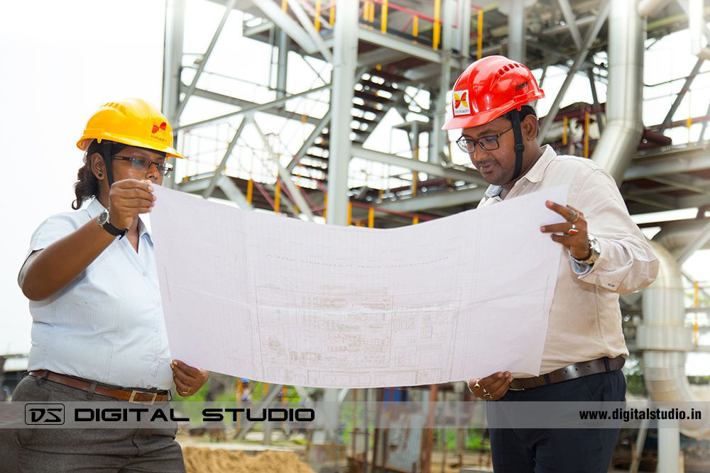 Two workers discussing a project in plant