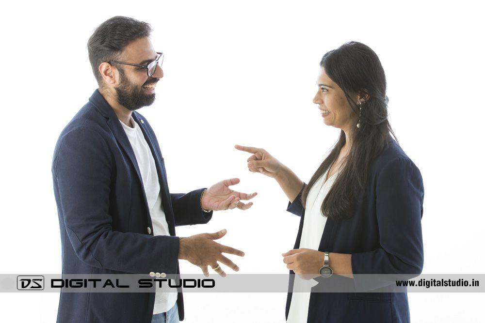 Couple gesturing on studio white background