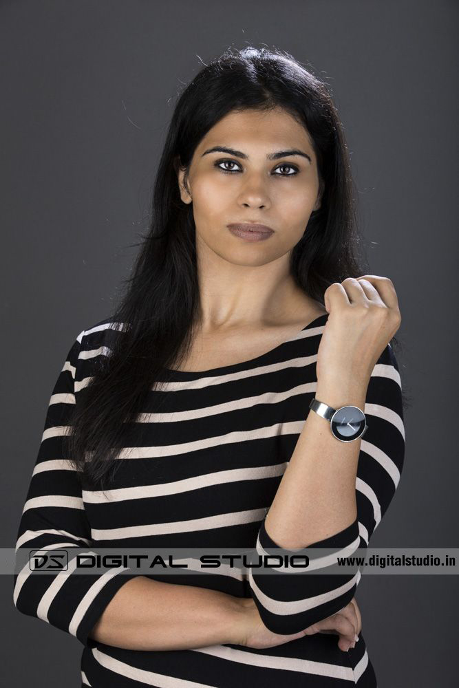 Female executive posing on grey backdrop