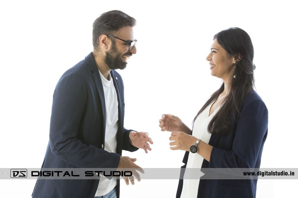 Laughing couple pose on white background