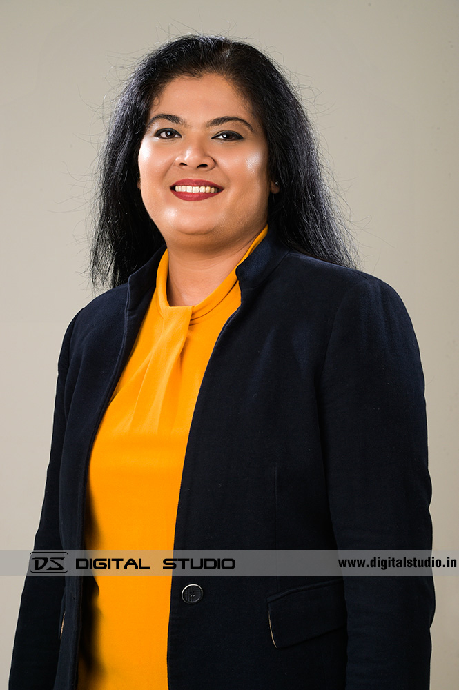Female corporate headshot with light grey backdrop
