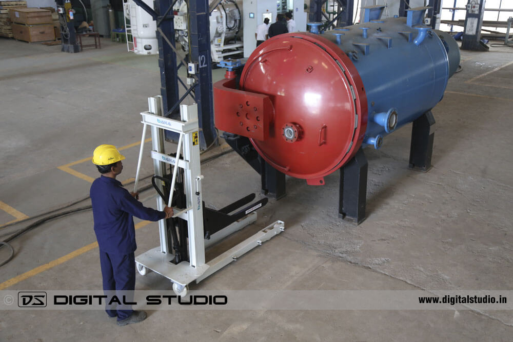 Worker adjusting the alignment of an industrial boiler