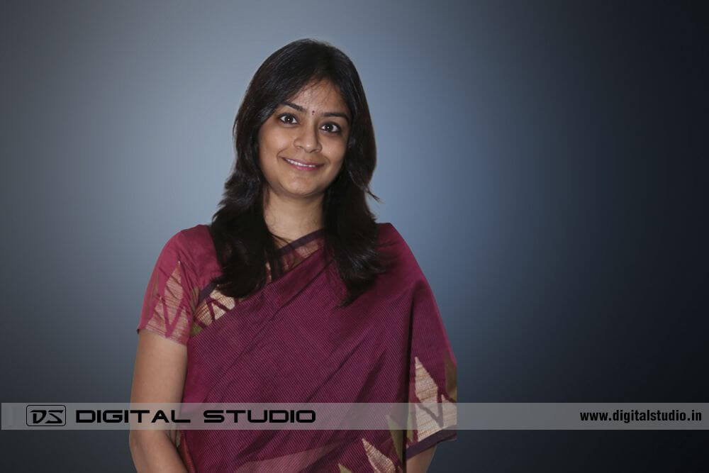 Lady executive in sari on creative background