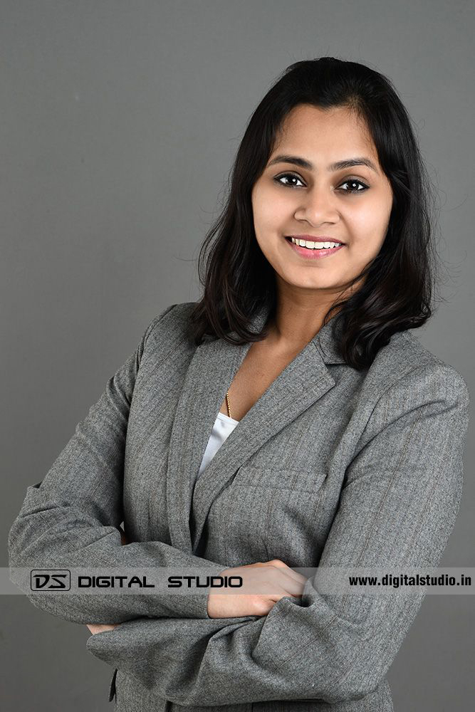 Arms Folded lady exectuive on grey backdrop