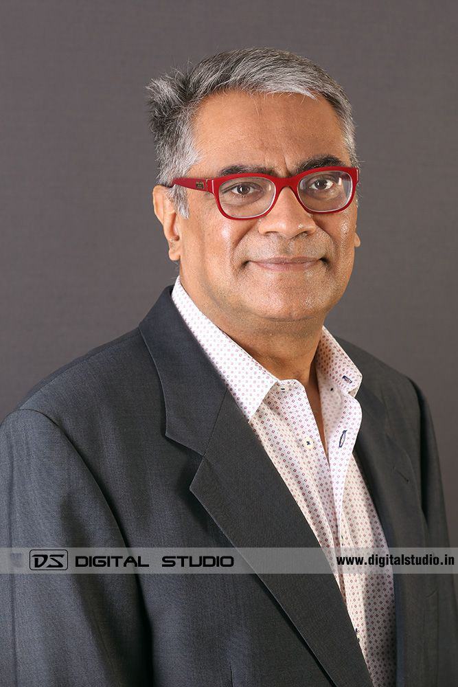 Profile photograph of male executive on grey backdrop