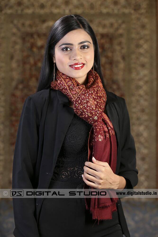 Embroidered shawl draped around model's neck 