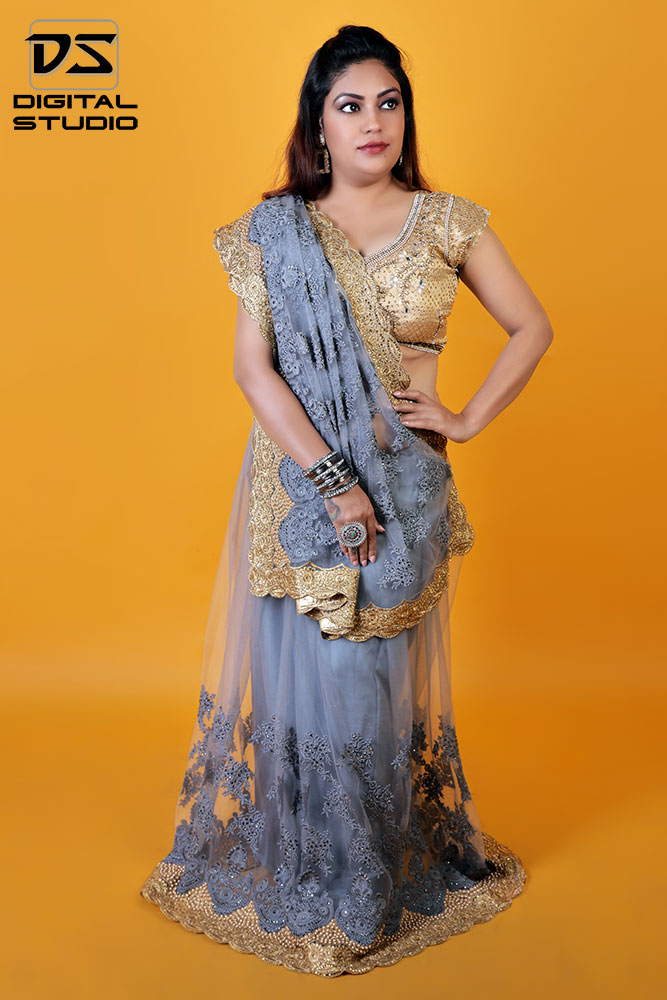 Indian model wearing sari on orange background