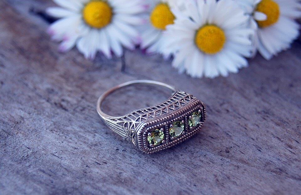 Diamond ring along with flowers in background