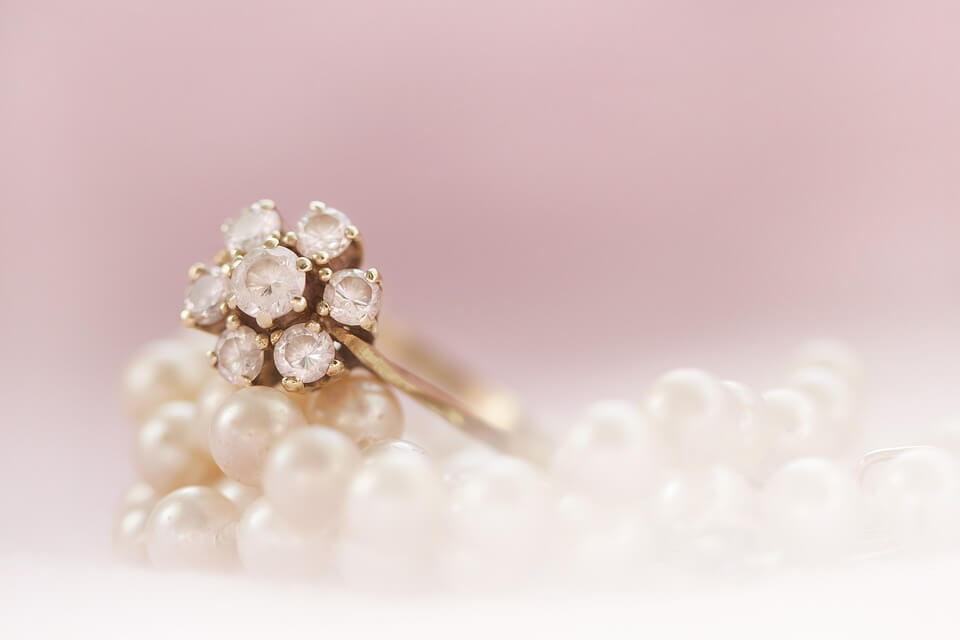 Creative photograph of diamond ring on pearls