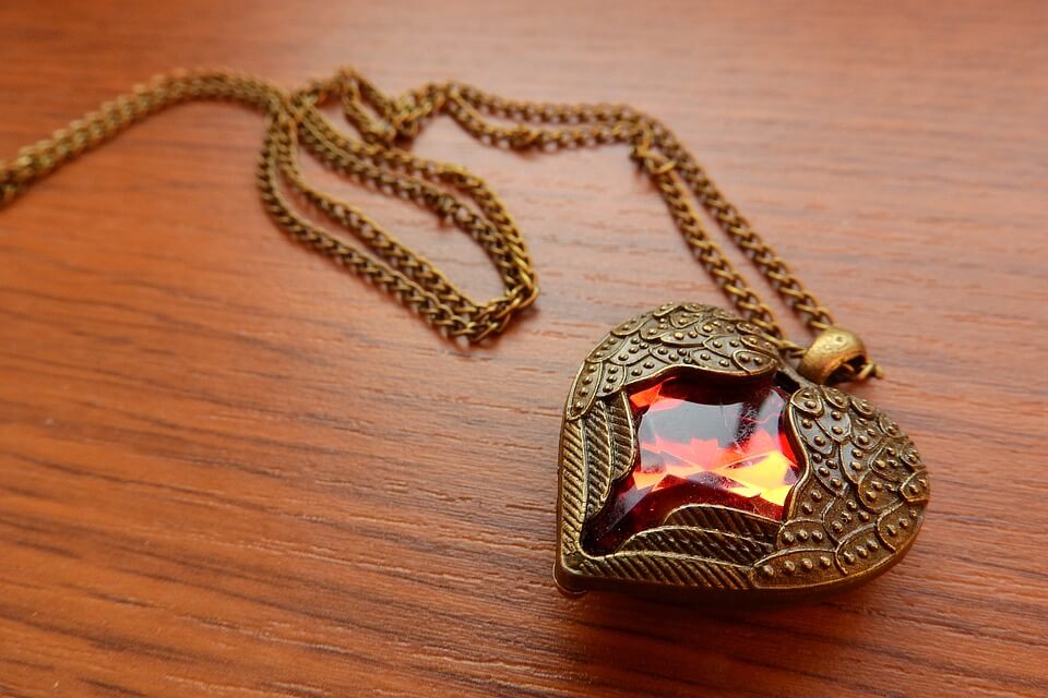 Heart shaped pendant on wooden table