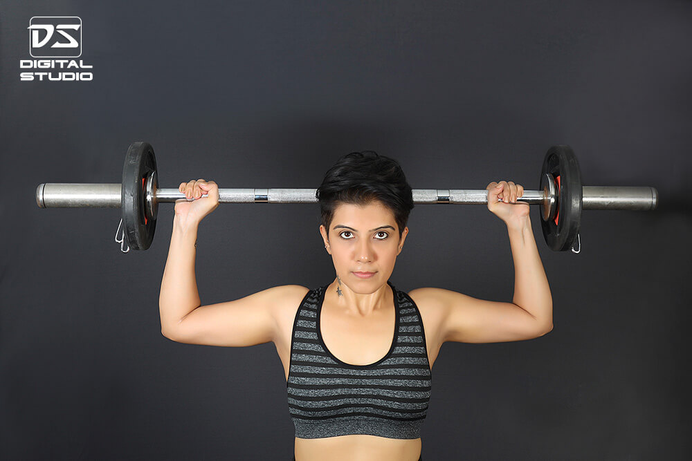 Barbell shoulder press with dark background