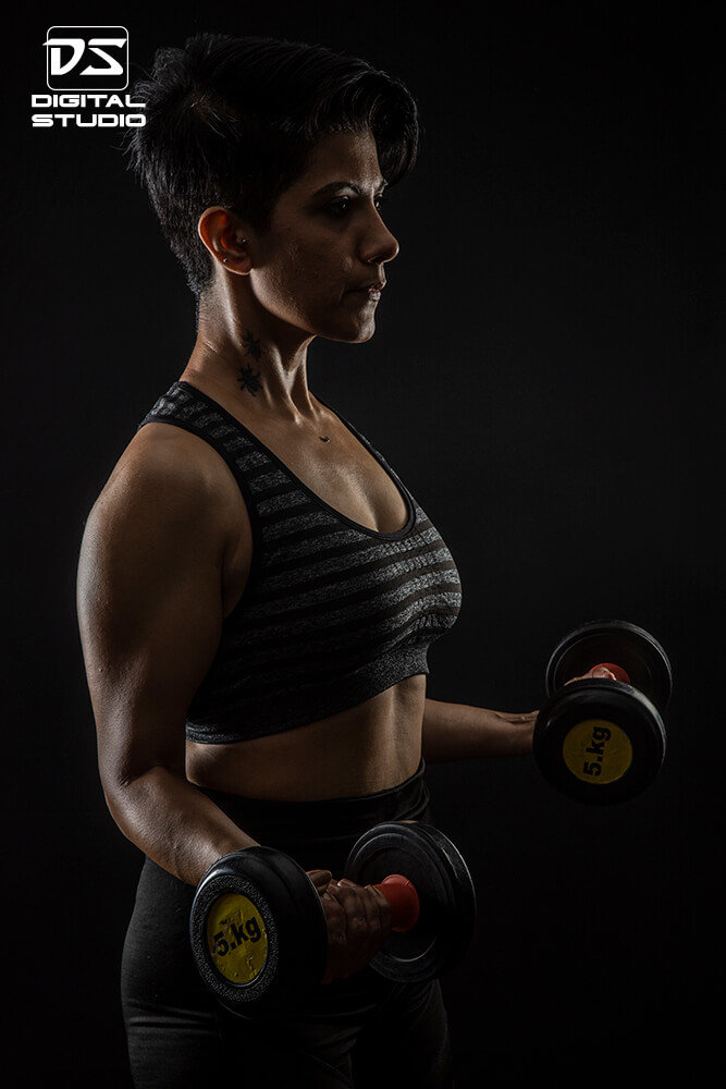 Dumbbell curls by female fitness model