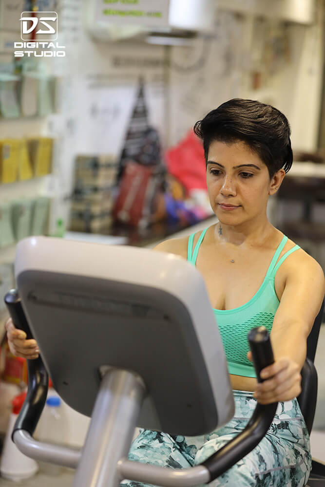 Lady fitness model doing cadio on stationary bike