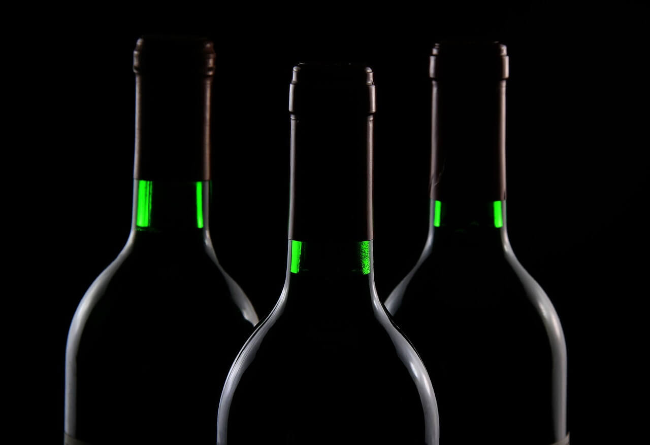 Three bottles on black background and rim lighting