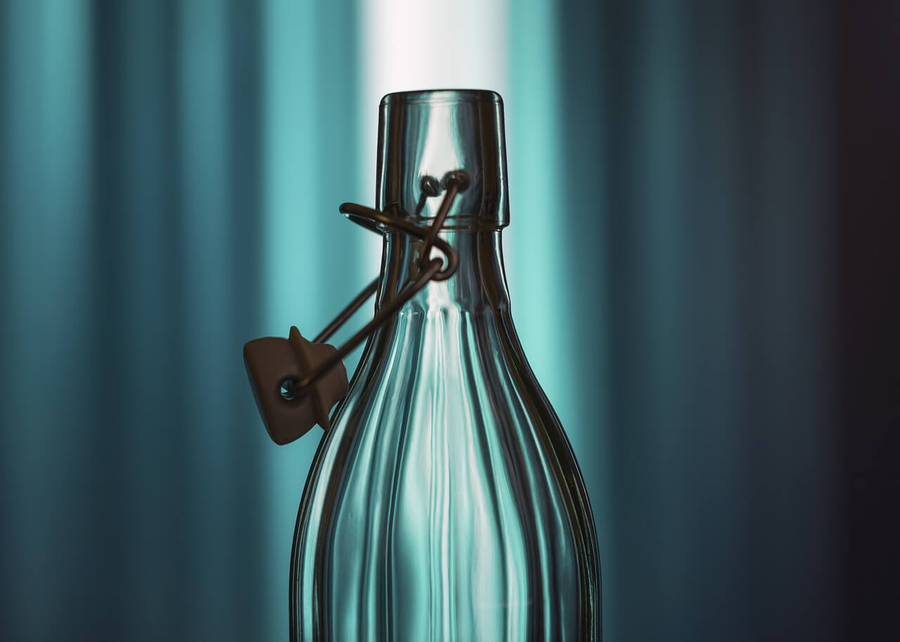 Lifestyle photograph of bottle with styling and blue background