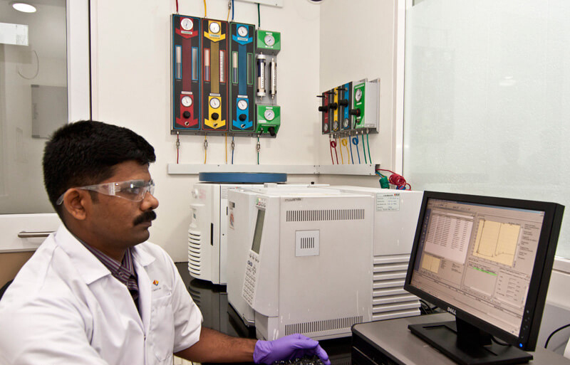 Lab technician working on a Computer in a pharma lab