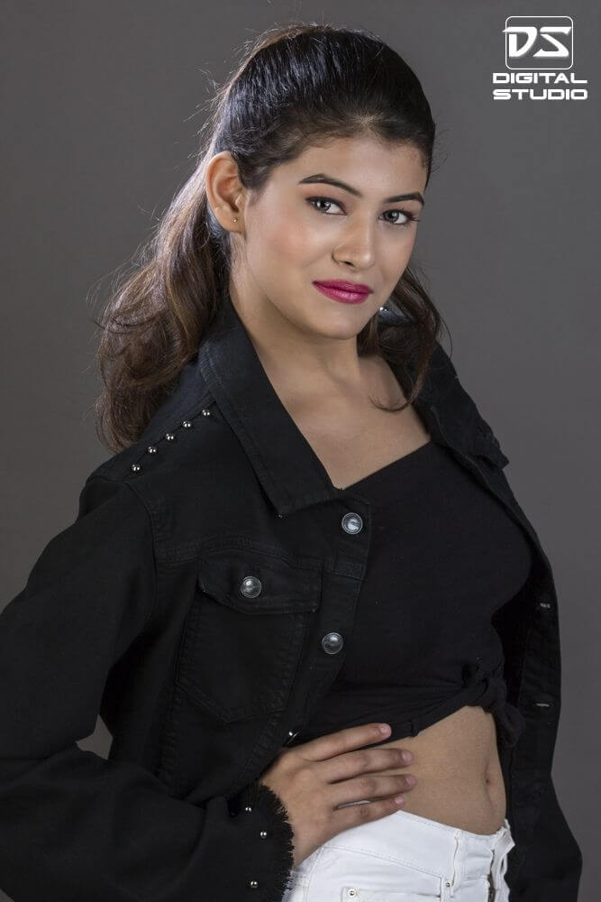 Female model wearing black jacket and black tube top