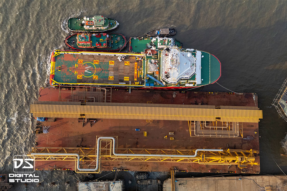 Barge and tug boats moored at the jetty - drone shot