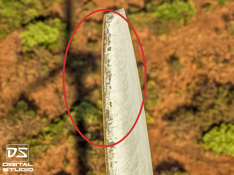 Wind turbine blade tip showing leading edge erosion and coating damage detected during drone inspection