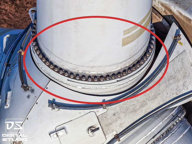 Wind turbine yaw bearing bolt ring showing corrosion on fasteners at the tower–nacelle interface during drone inspection