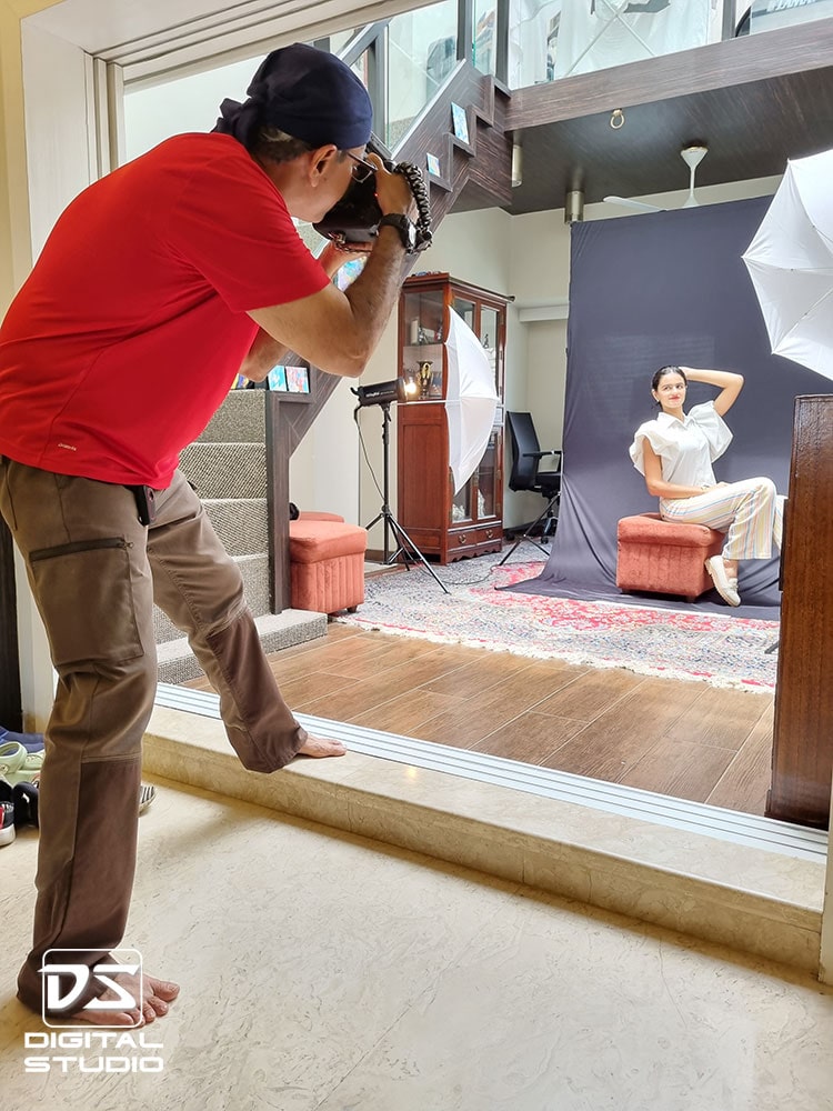 Photographer shooting a model at her home