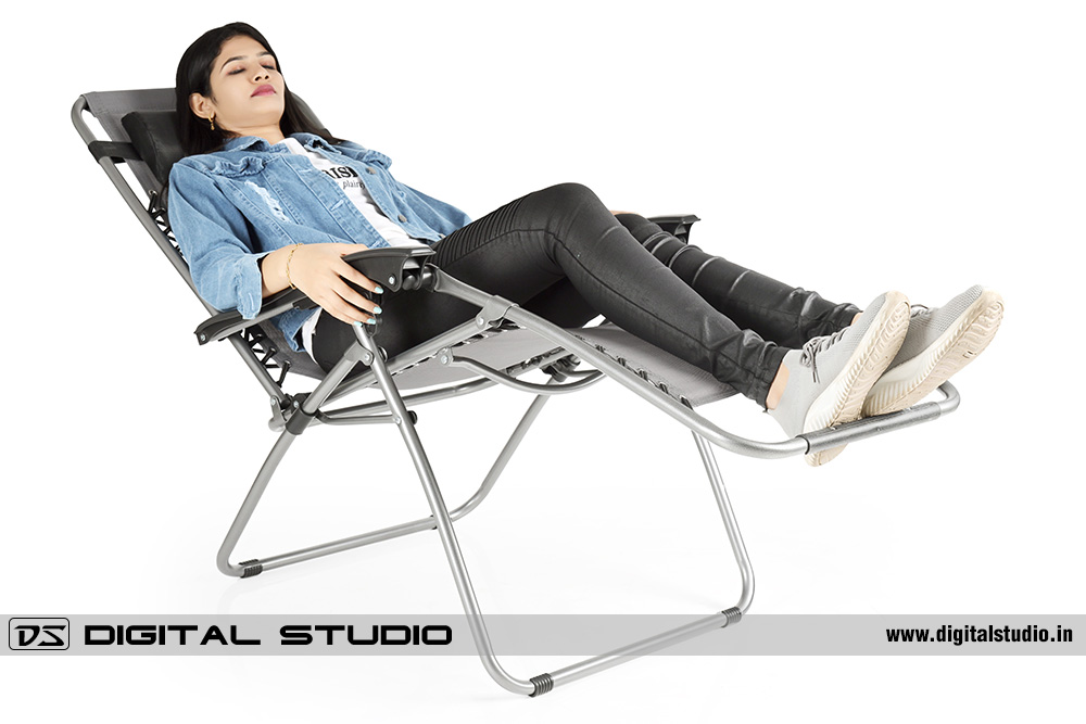 Model posing with garden recliner chair