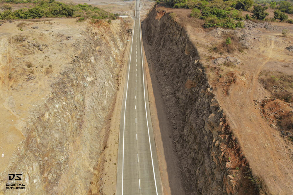 Drone documentation photograph of a highway rock cutting section on the Agardanda road corridor
