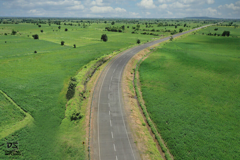 Drone documentation photograph of a highway corridor passing through green terrain in the Malewada Chimur region