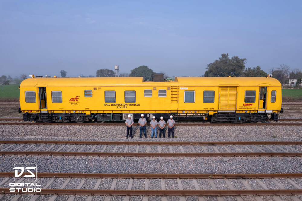Technicians waving in the front of the maintenance machine