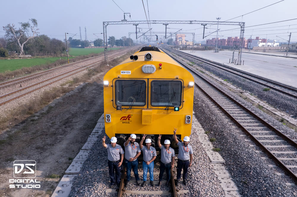 Drone shot of staff with hand up