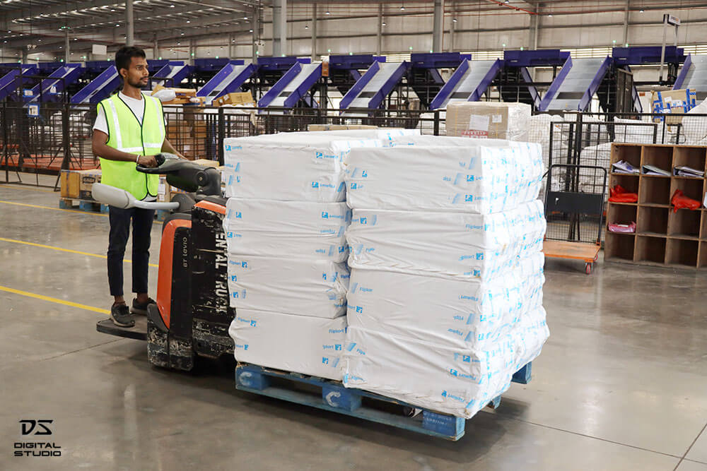 Forklift operator moving cartons inside the logistics warehouse during material handling