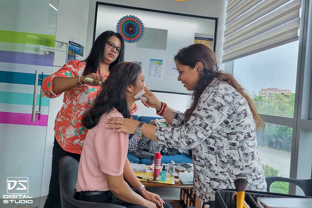 Hair and make-up artist working on client