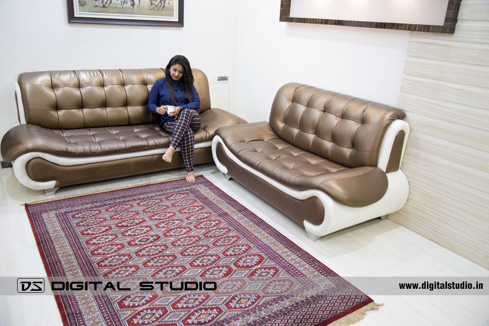 Lady having tea on sofa with geometric design carpet