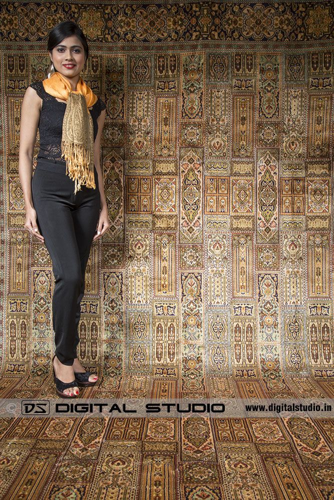 Model standing on Kashmir carpet