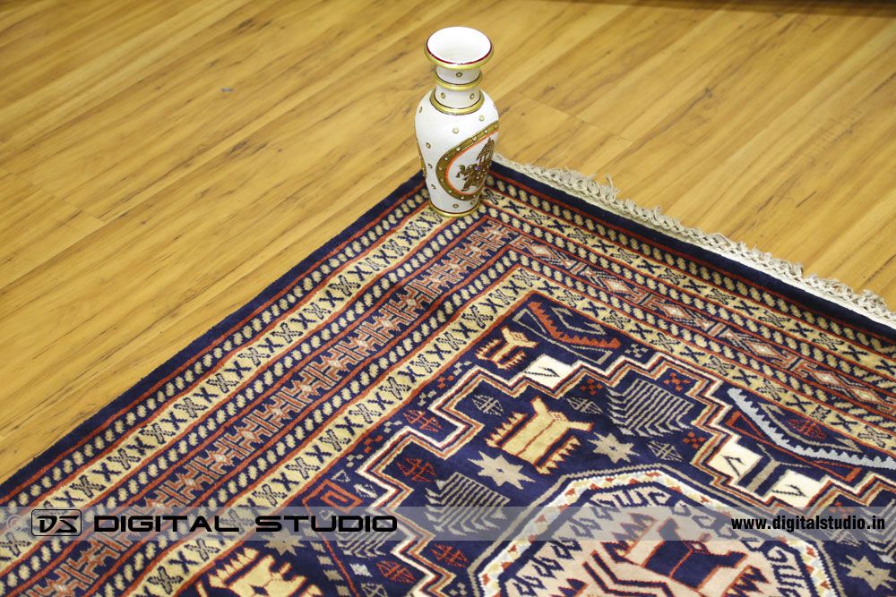 Red oriental carpet with flower vase